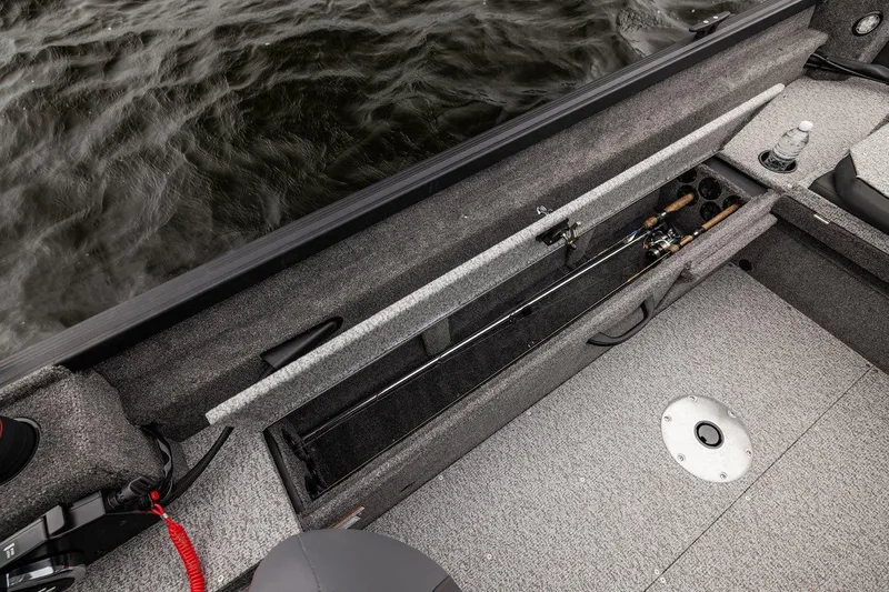 Slide: The Image of 2026 Alumacraft Voyageur 175 Sport boat interior with fishing rod storage. - 19