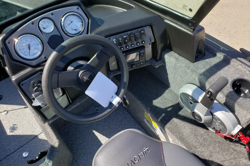 Slide: The Image of 2026 Alumacraft Voyageur 175 Sport dashboard with steering wheel and control panel. - 24