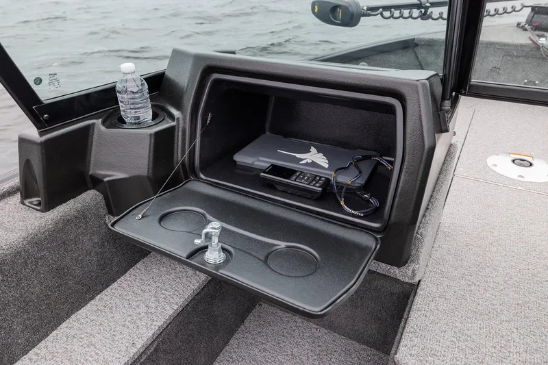 Slide: The Image of 2026 Alumacraft Voyageur 175 Sport boat interior with storage compartment and cup holder. - 9