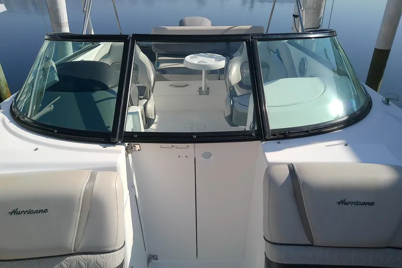 Slide: The Image of 2021 Hurricane SunDeck 2410 OB boat interior with seating and windshield. - 11