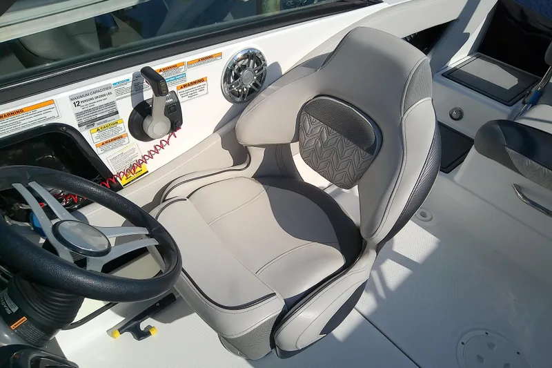 Slide: The Image of Captain's seat and steering wheel of 2021 Hurricane SunDeck 2410 OB boat interior. - 20
