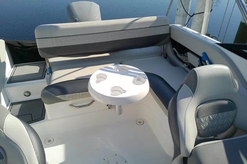 Slide: The Image of 2021 Hurricane SunDeck 2410 OB boat interior with seating and table, overlooking water. - 22