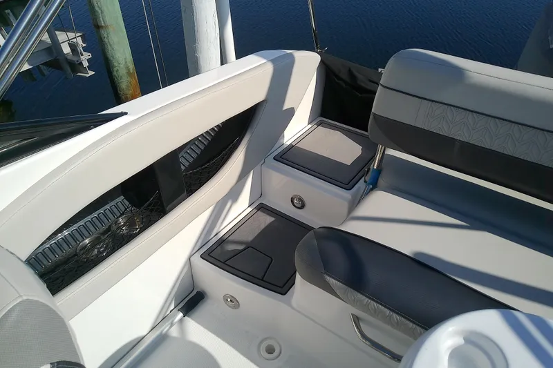 Slide: The Image of Interior seating of 2021 Hurricane SunDeck 2410 OB boat, featuring sleek design and storage compartments. - 23