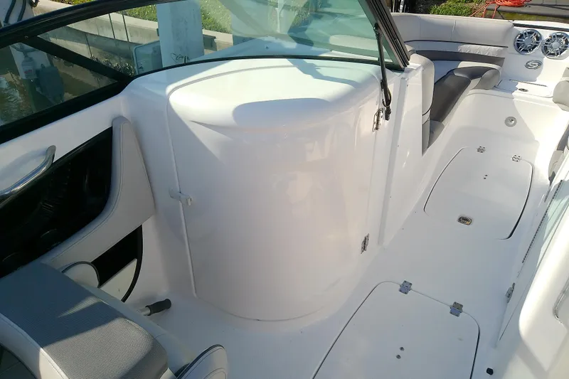 Slide: The Image of 2021 Hurricane SunDeck 2410 OB boat interior with seating and storage compartments. - 27