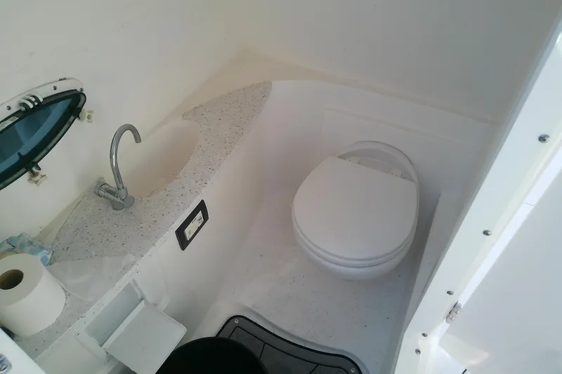 Slide: The Image of 2021 Hurricane SunDeck 2410 OB boat bathroom with sink and toilet. - 28