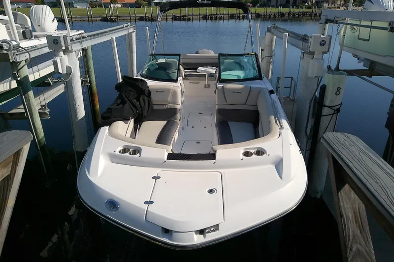 Slide: The Image of 2021 Hurricane SunDeck 2410 OB boat docked, featuring spacious seating and sleek design. - 3
