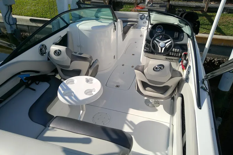 Slide: The Image of 2021 Hurricane SunDeck 2410 OB boat interior with seating and steering console. - 30