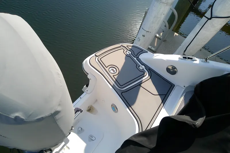 Slide: The Image of 2021 Hurricane SunDeck 2410 OB boat deck at dock, featuring sleek design and modern fittings. - 31