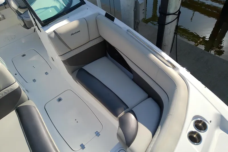 Slide: The Image of 2021 Hurricane SunDeck 2410 OB boat interior with comfortable seating and cup holders. - 5