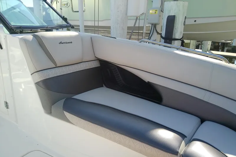 Slide: The Image of 2021 Hurricane SunDeck 2410 OB boat interior with cushioned seating. - 9
