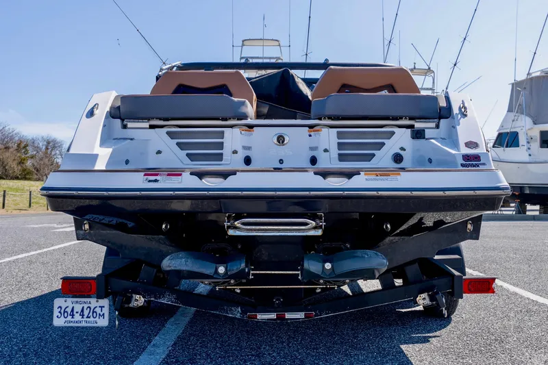 Slide: The Image of 2024 Scarab 235 ID boat rear view on trailer, showcasing sleek design and dual engines. - 13