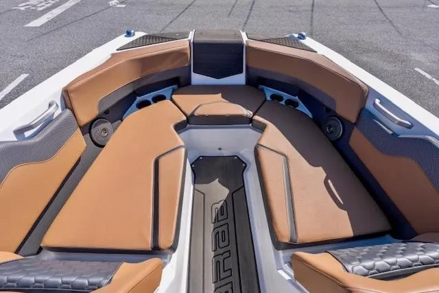 Slide: The Image of 2024 Scarab 235 ID boat interior with tan and black seating, modern design. - 8