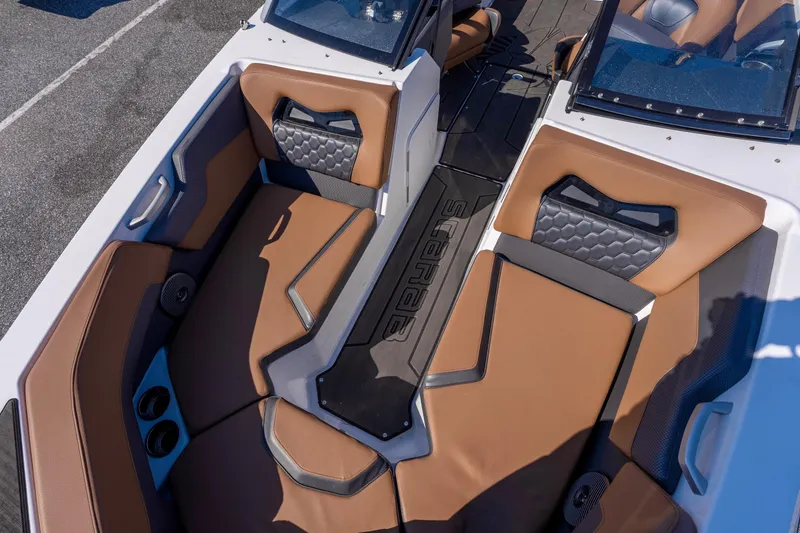 Slide: The Image of 2024 Scarab 235 ID boat interior with brown and black seating, modern design. - 10