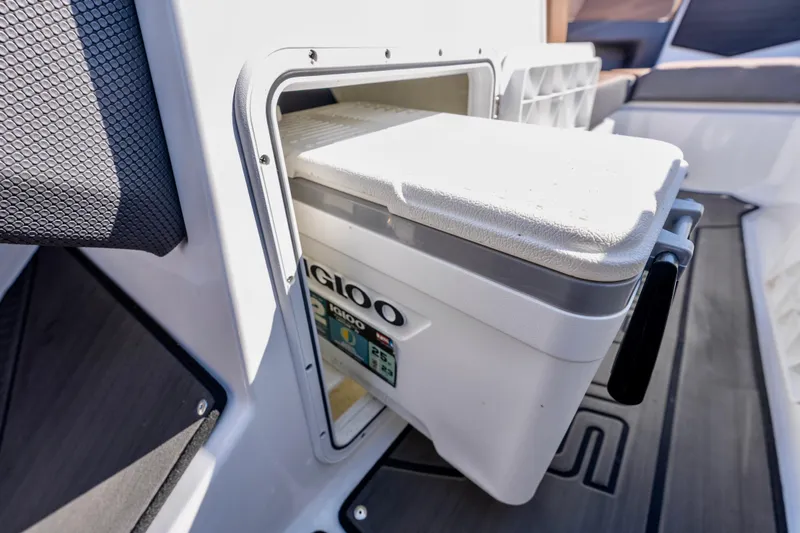 Slide: The Image of Built-in cooler compartment on 2024 Scarab 235 ID boat, featuring Igloo cooler. - 11