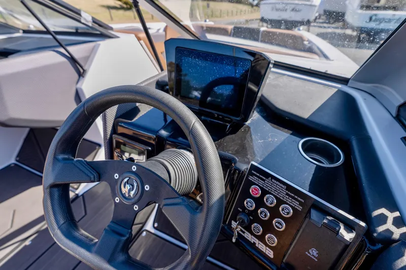 Slide: The Image of 2024 Scarab 235 ID boat in a garage, showcasing sleek design and modern features. - 2