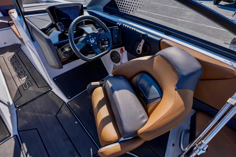 Slide: The Image of Steering wheel and dashboard of 2024 Scarab 235 ID boat, featuring modern controls and display. - 5