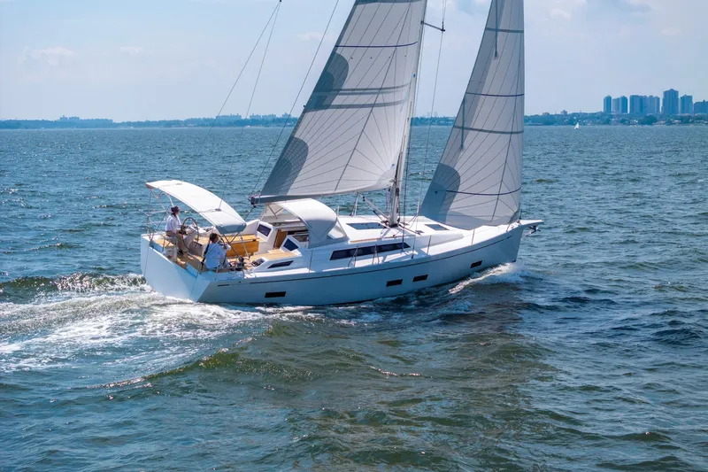 The Image of 2026 Grand Soleil 42 Long Cruise sailing on open water, city skyline in background. - 2