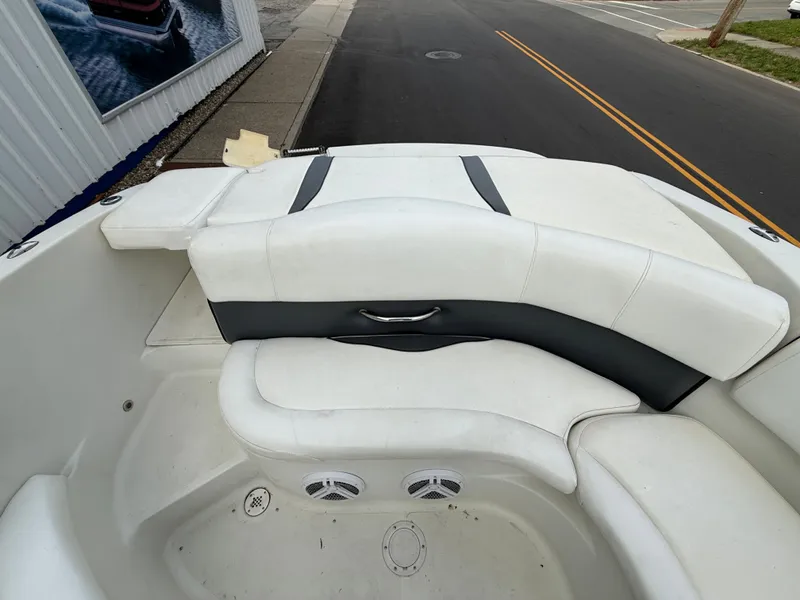 Slide: The Image of Interior of a 2007 Caravelle 237 LS Bowrider boat with white seating. - 12
