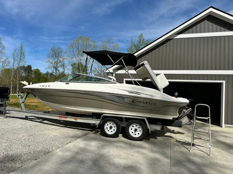 Slide: The Image of 2007 Caravelle 237 LS Bowrider on trailer in front of garage. - 18