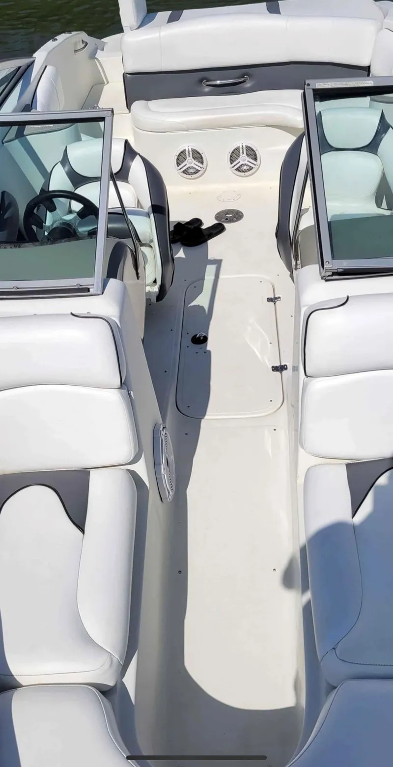 Slide: The Image of Interior of a 2007 Caravelle 237 LS Bowrider boat with white seating. - 23