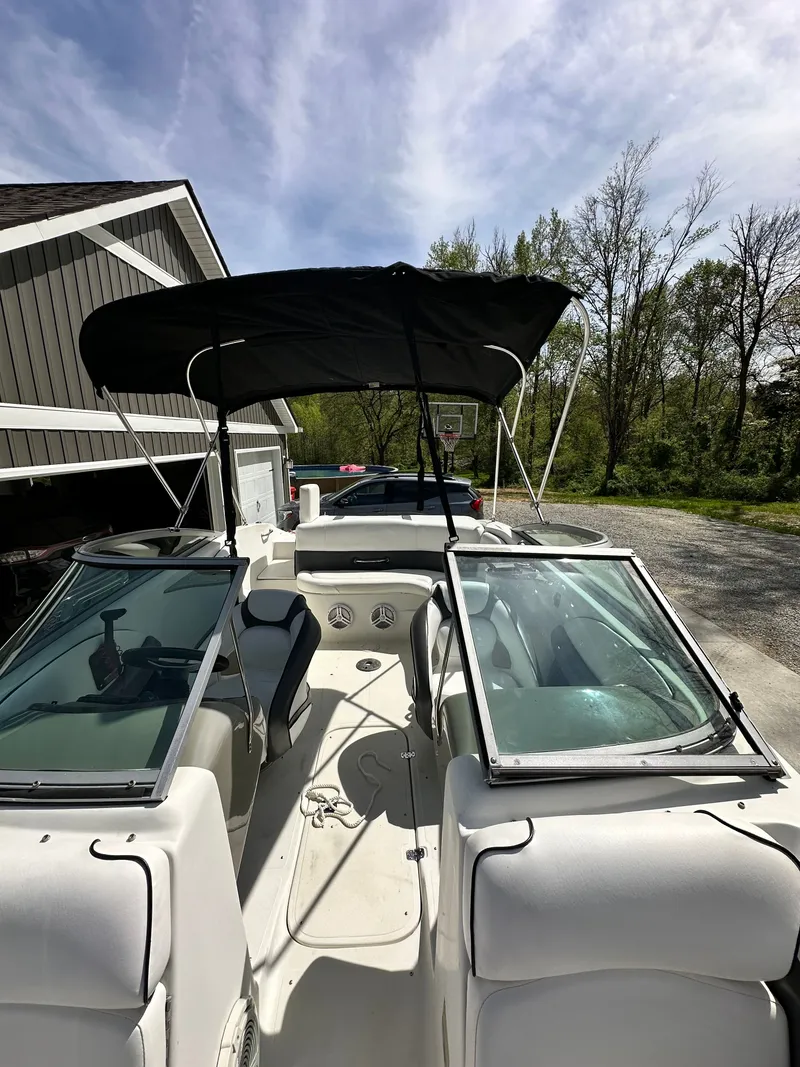 Slide: The Image of 2007 Caravelle 237 LS Bowrider boat with bimini top outdoors. - 27