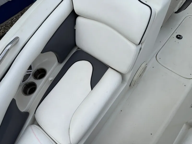 Slide: The Image of Interior of a 2007 Caravelle 237 LS Bowrider with white seating. - 4