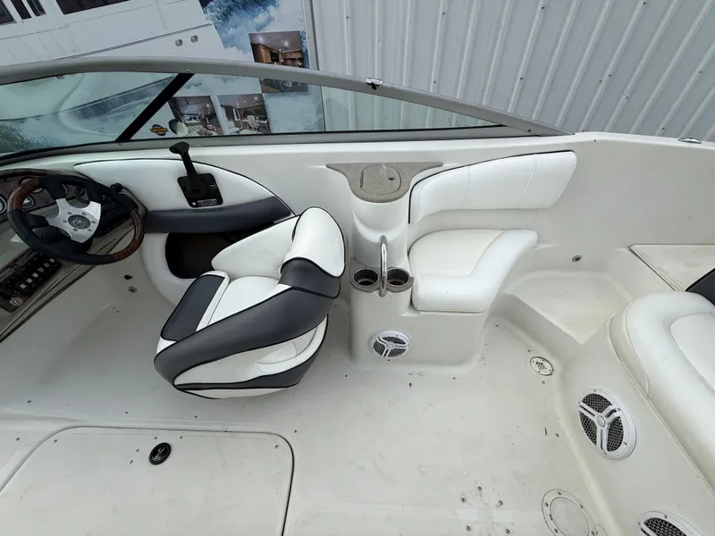 Slide: The Image of Interior of a 2007 Caravelle 237 LS Bowrider with white seating. - 6
