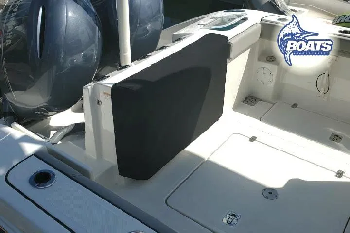 Slide: The Image of 2022 Pursuit S 268 Sport boat deck with dual engines and seating area. - 18