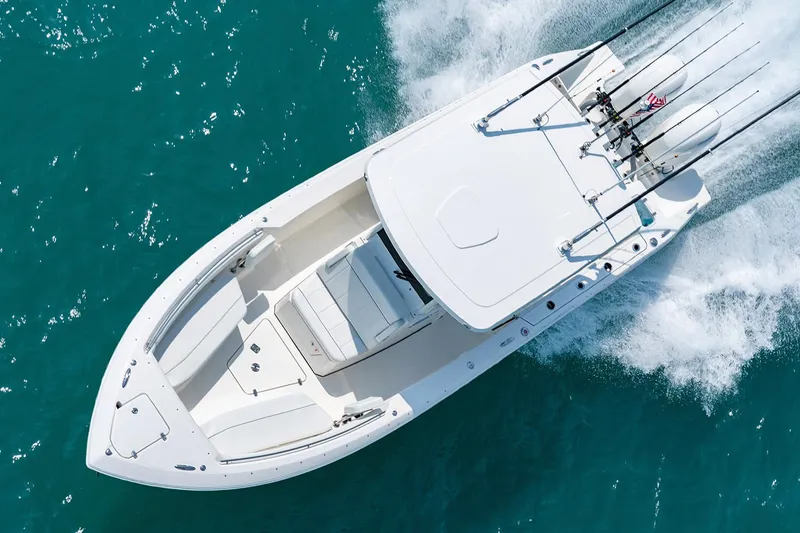 Slide: The Image of Manufacturer Provided Image: 2022 Pursuit S 268 Sport boat cruising on clear blue water. - 5