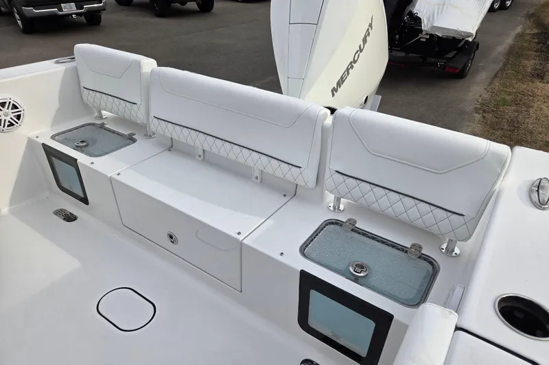 Slide: The Image of 2026 Sportsman Heritage 231 Center Console boat interior with white seating and storage compartments. - 10