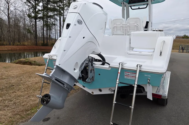 Slide: The Image of 2026 Sportsman Heritage 231 Center Console boat with outboard motor and ladder. - 3