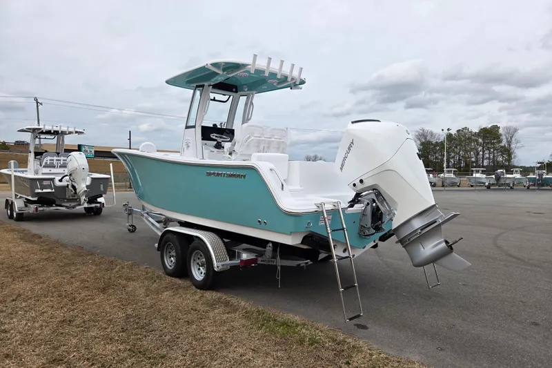 Slide: The Image of 2026 Sportsman Heritage 231 Center Console boat on trailer, featuring a powerful Mercury outboard engine. - 5
