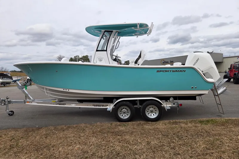 Slide: The Image of 2026 Sportsman Heritage 231 Center Console boat on trailer, turquoise hull, outdoor setting. - 6