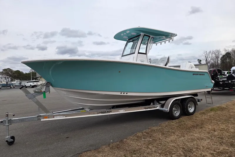 Slide: The Image of 2026 Sportsman Heritage 231 Center Console boat on trailer, parked outdoors. - 7