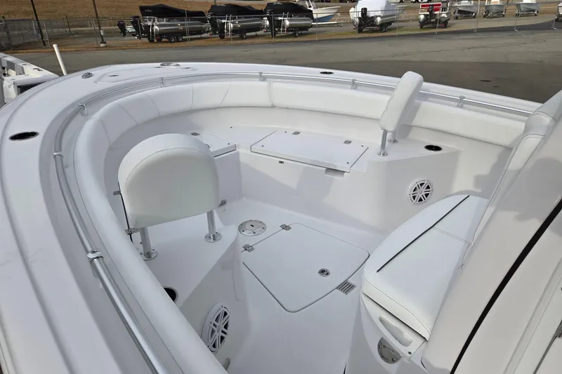Slide: The Image of 2026 Sportsman Heritage 231 Center Console boat interior with white seating and storage compartments. - 8