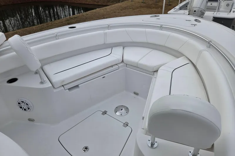 Slide: The Image of 2026 Sportsman Heritage 231 Center Console boat with white cushioned seating area. - 9