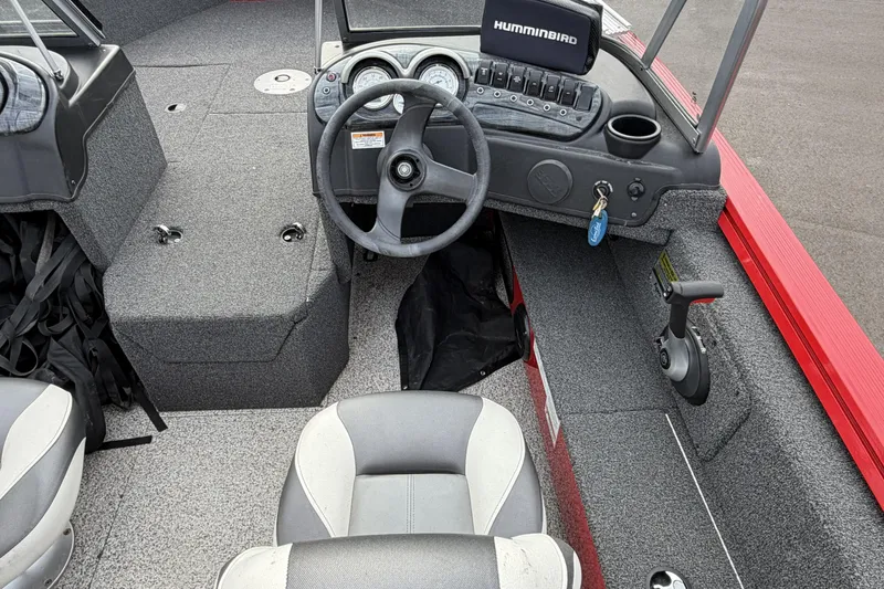 Slide: The Image of 2023 Polar Kraft Frontier 179 WT boat interior with steering wheel and control panel. - 13