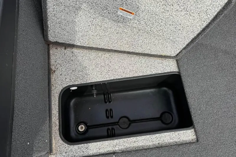 Slide: The Image of 2023 Polar Kraft Frontier 179 WT boat storage compartment, open with visible interior. - 18
