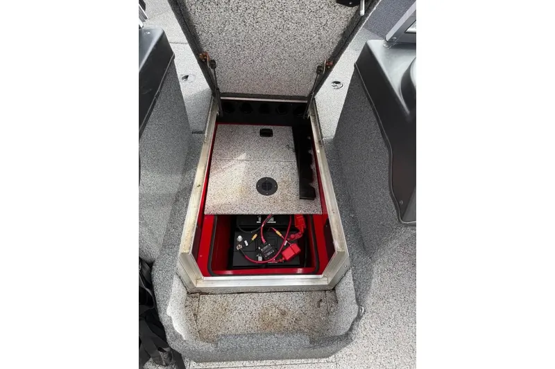 Slide: The Image of Open storage compartment in 2023 Polar Kraft Frontier 179 WT boat, revealing battery setup. - 19