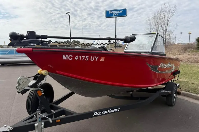 Slide: The Image of 2023 Polar Kraft Frontier 179 WT boat on trailer, parked near Rodeway Inn. - 2