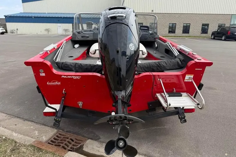 Slide: The Image of 2023 Polar Kraft Frontier 179 WT boat, red exterior, rear view with outboard motor. - 5