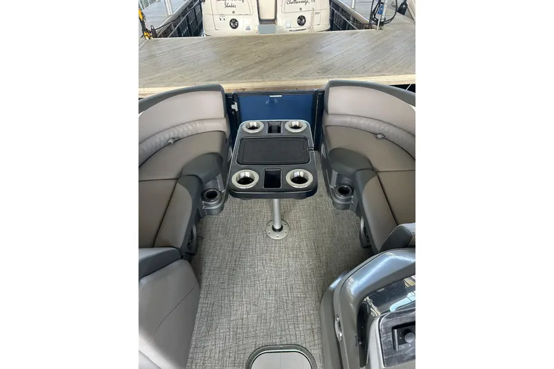 Slide: The Image of 2022 Avalon 2485 LSZ QL boat interior with seating and table, featuring cup holders. - 3