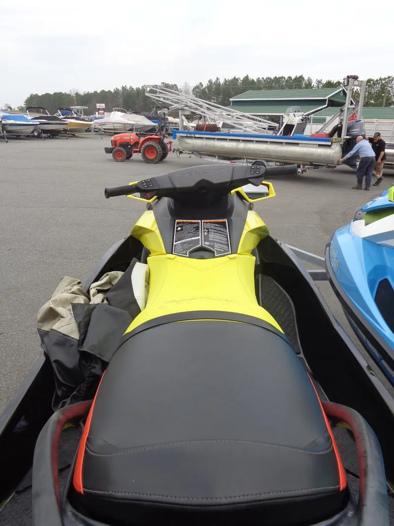 Slide: The Image of 2015 Sea-Doo GTR™ 215 jet ski parked in a lot. - 15