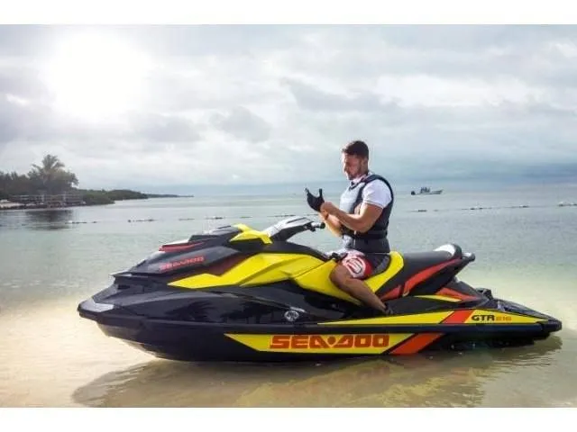 Slide: The Image of Man on Sea-Doo GTR™ 215 jet ski at beach, 2015 model. - 34