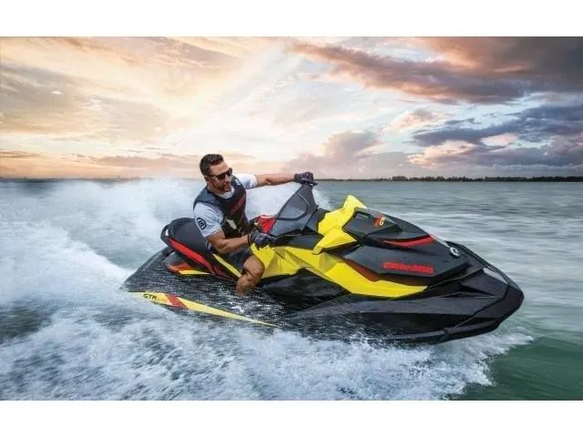 Slide: The Image of Man riding 2015 Sea-Doo GTR™ 215 jet ski at sunset. - 35