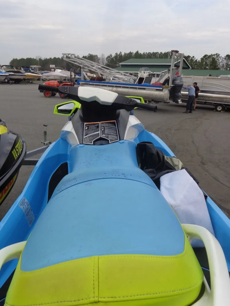 Slide: The Image of 2015 Sea-Doo GTI SE 130 jet ski parked outdoors. - 11