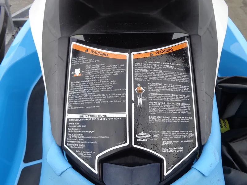 Slide: The Image of Warning labels on a 2015 Sea-Doo GTI SE 130 jet ski. - 13