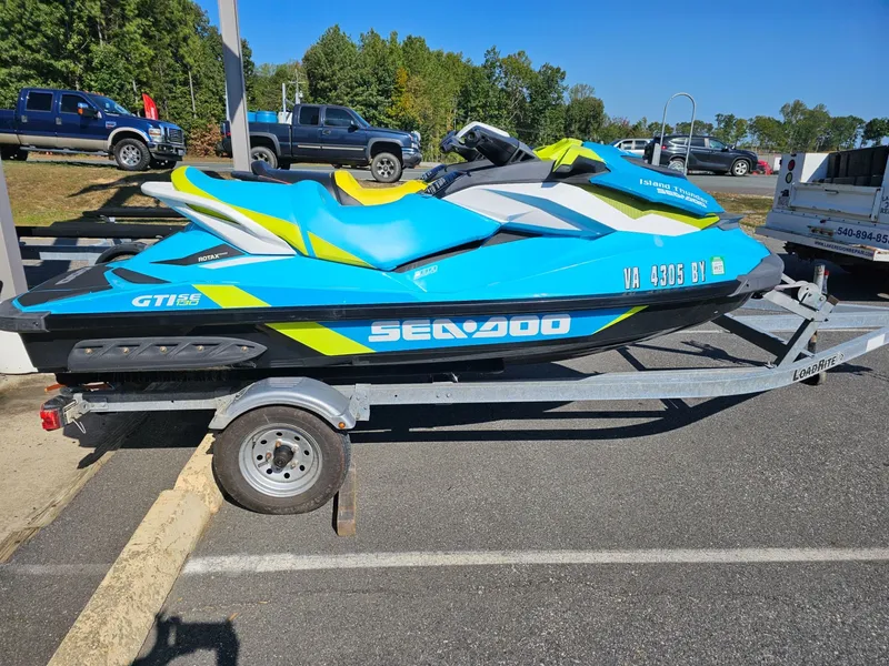 Slide: The Image of 2015 Sea-Doo GTI SE 130 jet ski on trailer, blue and yellow. - 23