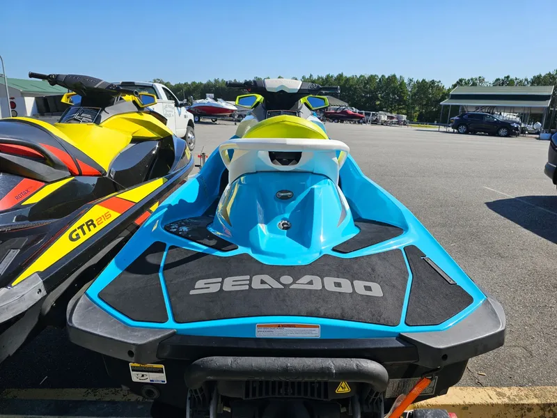 Slide: The Image of 2015 Sea-Doo GTI SE 130 jet ski in parking lot, blue and yellow. - 24