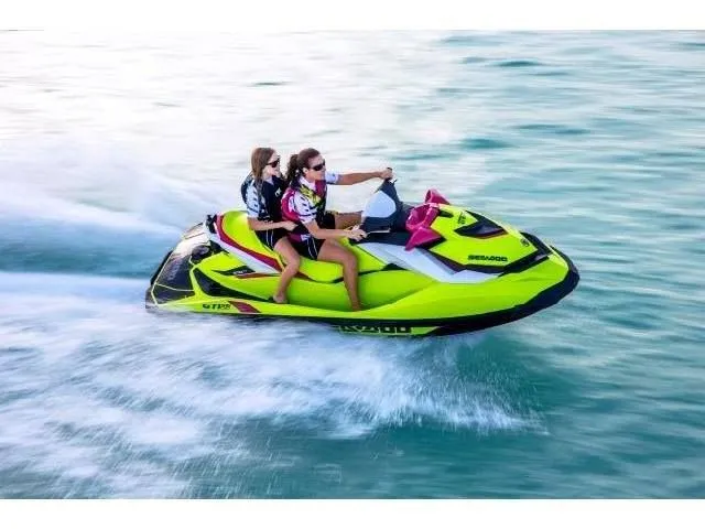 Slide: The Image of Two people riding 2015 Sea-Doo GTI SE 130 on water. - 30
